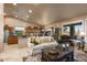 Bright living room showcases an open layout with a kitchen, dining area, and access to an outdoor patio at 15109 W Waterford Dr, Surprise, AZ 85374