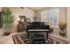 Elegant living room featuring a black piano and plantation shutters adding a touch of sophistication at 15109 W Waterford Dr, Surprise, AZ 85374