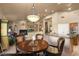Open floor plan features living room with fireplace, custom built-ins, breakfast nook, and kitchen at 15109 W Waterford Dr, Surprise, AZ 85374
