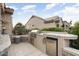Built-in outdoor kitchen with grill, sink, refrigerator, and stone accents for easy entertaining at 15109 W Waterford Dr, Surprise, AZ 85374
