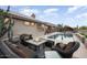 Inviting patio area with a fire pit, pool, and lush landscaping, creating a backyard retreat at 15109 W Waterford Dr, Surprise, AZ 85374