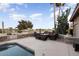Inviting outdoor seating around a fire pit beside a sparkling pool, perfect for entertaining at 15109 W Waterford Dr, Surprise, AZ 85374