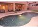 Relaxing backyard features a private pool, covered patio with lounge seating, and manicured landscaping at 15229 S 18Th Dr, Phoenix, AZ 85045