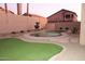 Private backyard oasis featuring a kidney-shaped pool, artificial turf, and desert landscaping at 15229 S 18Th Dr, Phoenix, AZ 85045