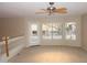 Bright and airy bonus room with carpet flooring, a ceiling fan, and a door leading to a balcony at 15229 S 18Th Dr, Phoenix, AZ 85045