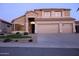 Charming two-story home with a three-car garage, desert landscaping, and a well-manicured front yard at 15229 S 18Th Dr, Phoenix, AZ 85045