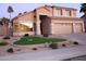 Charming two-story home with a three-car garage, desert landscaping, and a well-manicured front yard at 15229 S 18Th Dr, Phoenix, AZ 85045