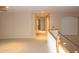 Bright hallway featuring neutral paint and a staircase with wood handrail and white risers at 15229 S 18Th Dr, Phoenix, AZ 85045