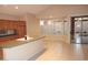 Bright kitchen area with tile flooring, a kitchen island and sliding doors leading to a backyard at 15229 S 18Th Dr, Phoenix, AZ 85045