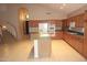 Open-concept kitchen with modern appliances, tile floors, and access to a staircase at 15229 S 18Th Dr, Phoenix, AZ 85045
