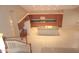 Open-concept kitchen featuring a large island, spacious tile floor, wood cabinets, and a built-in desk area at 15229 S 18Th Dr, Phoenix, AZ 85045