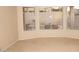 Inviting living room featuring large windows offering natural light and serene outdoor views at 15229 S 18Th Dr, Phoenix, AZ 85045