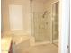 Bright bathroom showcasing a soaking tub and separate glass shower stall with modern fixtures at 15229 S 18Th Dr, Phoenix, AZ 85045