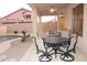 Covered patio with outdoor seating area and ceiling fan, perfect for entertaining by the pool at 15229 S 18Th Dr, Phoenix, AZ 85045