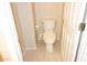 Clean half-bathroom with tile floor featuring a toilet and convenient roll paper holder at 15229 S 18Th Dr, Phoenix, AZ 85045