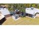 Large backyard with green grass, a storage shed, detached garage and covered patio area at 1529 W Rovey Ave, Phoenix, AZ 85015