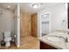 This bathroom features a step-in shower, toilet, and double sink vanity with granite counters at 1529 W Rovey Ave, Phoenix, AZ 85015