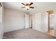 Bright, spacious bedroom with neutral walls, plush carpeting, and a ceiling fan at 1529 W Rovey Ave, Phoenix, AZ 85015