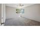 Bright bedroom featuring neutral walls, plush carpeting, a ceiling fan, and a sun-filled window at 1529 W Rovey Ave, Phoenix, AZ 85015