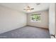 Bright bedroom featuring neutral walls, plush carpeting, and a large, sun-filled window at 1529 W Rovey Ave, Phoenix, AZ 85015