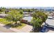 Charming single-story brick home with well-maintained lawn, mature trees, and long driveway at 1529 W Rovey Ave, Phoenix, AZ 85015