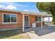 Welcoming brick home featuring a covered entrance, a well-kept yard, and large windows at 1529 W Rovey Ave, Phoenix, AZ 85015