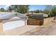 Detached garage and walled yard featuring a secure wooden gate providing privacy at 1529 W Rovey Ave, Phoenix, AZ 85015