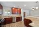 The kitchen offers wood cabinets, granite countertops, stainless steel appliances, and wood-look floors at 1529 W Rovey Ave, Phoenix, AZ 85015