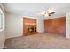 Cozy living room with a classic brick fireplace, carpet flooring and ceiling fan at 1529 W Rovey Ave, Phoenix, AZ 85015