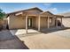 View of covered patio with sliding glass door entry, and low-maintenance backyard landscaping at 16188 W Boca Raton Rd, Surprise, AZ 85379