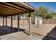 Backyard with a covered patio area and a shed, with gravel accents and low-maintenance landscaping at 16188 W Boca Raton Rd, Surprise, AZ 85379