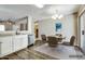 Bright dining area with a modern light fixture and convenient access to kitchen at 16188 W Boca Raton Rd, Surprise, AZ 85379