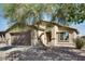 Charming single-story home with a landscaped front yard and mature shade tree at 16188 W Boca Raton Rd, Surprise, AZ 85379