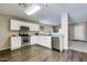 Well-equipped kitchen with stainless steel appliances, white cabinets, and modern flooring at 16188 W Boca Raton Rd, Surprise, AZ 85379