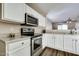 Modern kitchen featuring white cabinets, stainless steel appliances, and granite countertops at 16188 W Boca Raton Rd, Surprise, AZ 85379