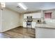Bright kitchen features white cabinets, stainless steel appliances, and granite countertops at 16188 W Boca Raton Rd, Surprise, AZ 85379