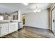 Open-concept kitchen with stainless steel dishwasher, ample counter space and modern chandelier at 16188 W Boca Raton Rd, Surprise, AZ 85379