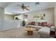 Inviting living room featuring a ceiling fan, neutral walls, and cozy furnishings at 16188 W Boca Raton Rd, Surprise, AZ 85379