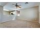 Comfortable living room with carpet flooring and an open view to the kitchen at 16188 W Boca Raton Rd, Surprise, AZ 85379
