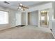 Bright and airy living room featuring neutral carpet and a ceiling fan at 16188 W Boca Raton Rd, Surprise, AZ 85379