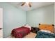 A colorful bedroom featuring two twin beds, carpet floor and natural light from a window with blinds at 1633 W Lacewood Pl, Phoenix, AZ 85045