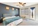 Main bedroom featuring a queen bed, a ceiling fan, and a door, offering a relaxing space at 1633 W Lacewood Pl, Phoenix, AZ 85045