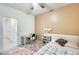 Bedroom with neutral carpet, a ceiling fan, and a twin bed next to a desk offering a comfortable space at 1633 W Lacewood Pl, Phoenix, AZ 85045