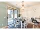 Bright dining area with modern lighting fixture and sliding door access to the backyard at 1633 W Lacewood Pl, Phoenix, AZ 85045