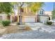 Charming two-story home showcasing a xeriscaped front yard with a mature tree providing shade at 1633 W Lacewood Pl, Phoenix, AZ 85045
