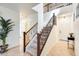 Bright foyer features a staircase with decorative iron balusters and neutral tile flooring at 1633 W Lacewood Pl, Phoenix, AZ 85045