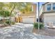 Two-story house showcasing a two-car garage, a spacious driveway, and beautiful trees at 1633 W Lacewood Pl, Phoenix, AZ 85045
