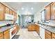 Open kitchen with wood cabinetry, modern appliances and seamless flow to dining area at 1633 W Lacewood Pl, Phoenix, AZ 85045