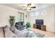 Inviting living room with gray sofas, a ceiling fan, and a decorative rug, perfect for relaxation and entertaining at 1633 W Lacewood Pl, Phoenix, AZ 85045