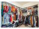 A walk-in closet with an abundance of clothing and storage at 1633 W Lacewood Pl, Phoenix, AZ 85045